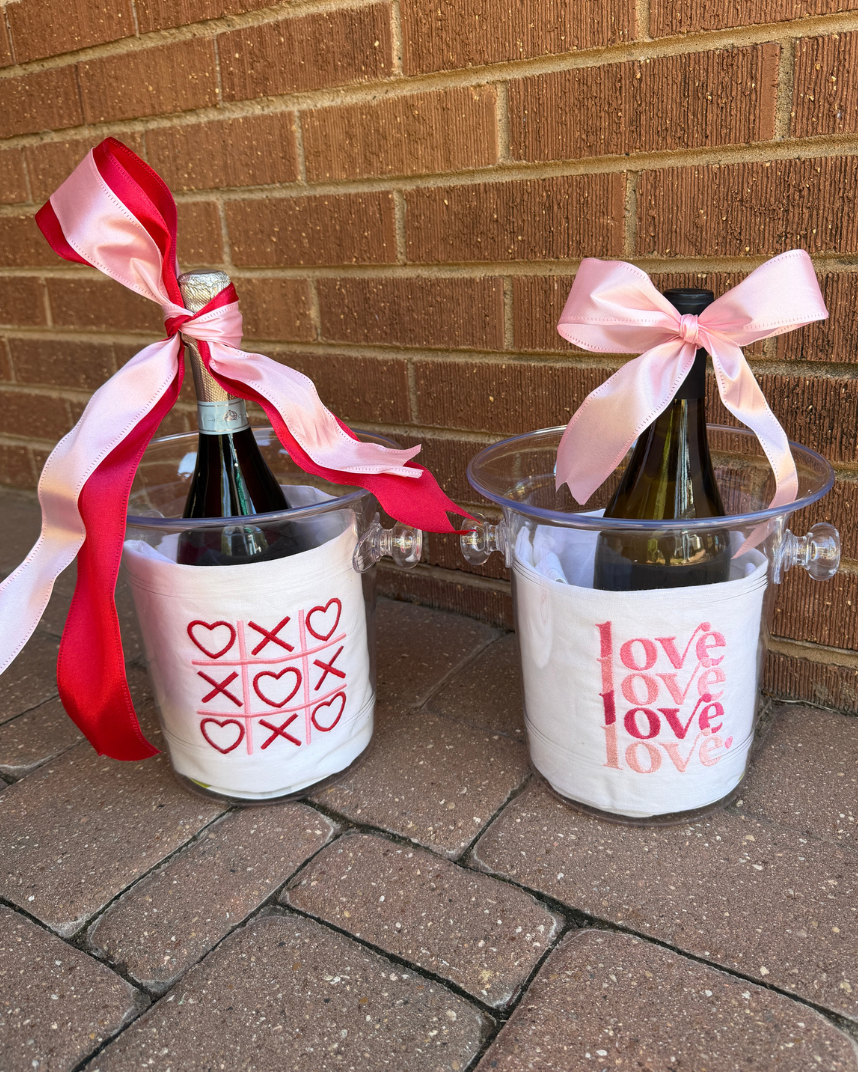 Embroidered tea towels with ice buckets with ribbons.
